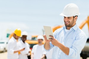 Male engineer at a construction site with a tablet computer